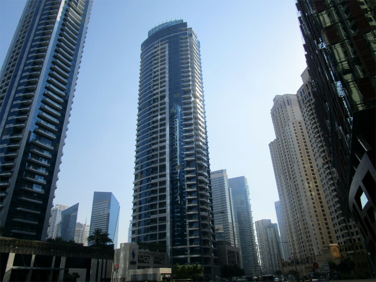 Oval-shaped metallic skyscrapers along a street