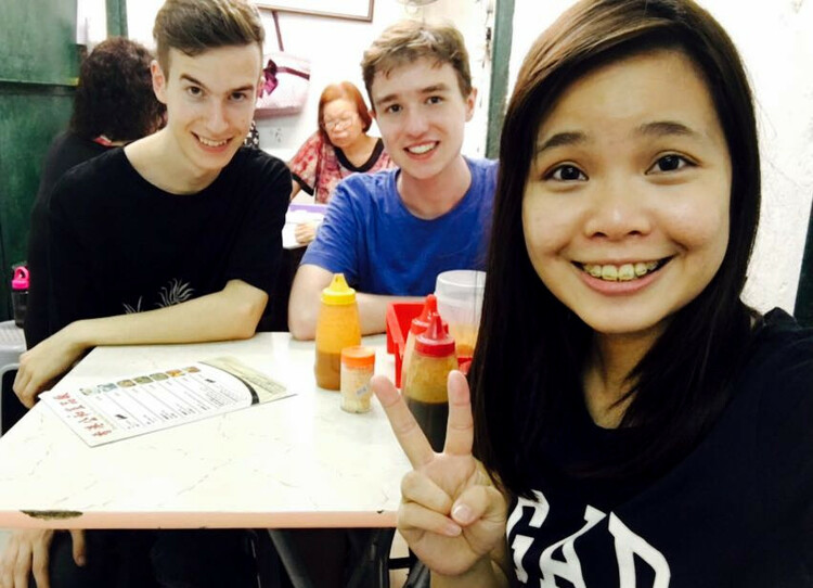 Group picture showing Nils, Jan, and Vickie around a white plastic table in a restaurant