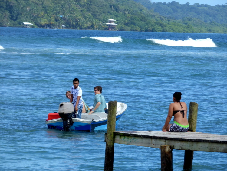 Willi and Nils in a small boat being driven away from a pier