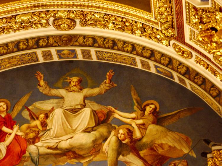 A fresco showing god and several angels with elaborate golden ornaments